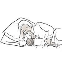 Babaeng nagpapasuso ng sanggol sa pamamagitan ng side-lying hold.
